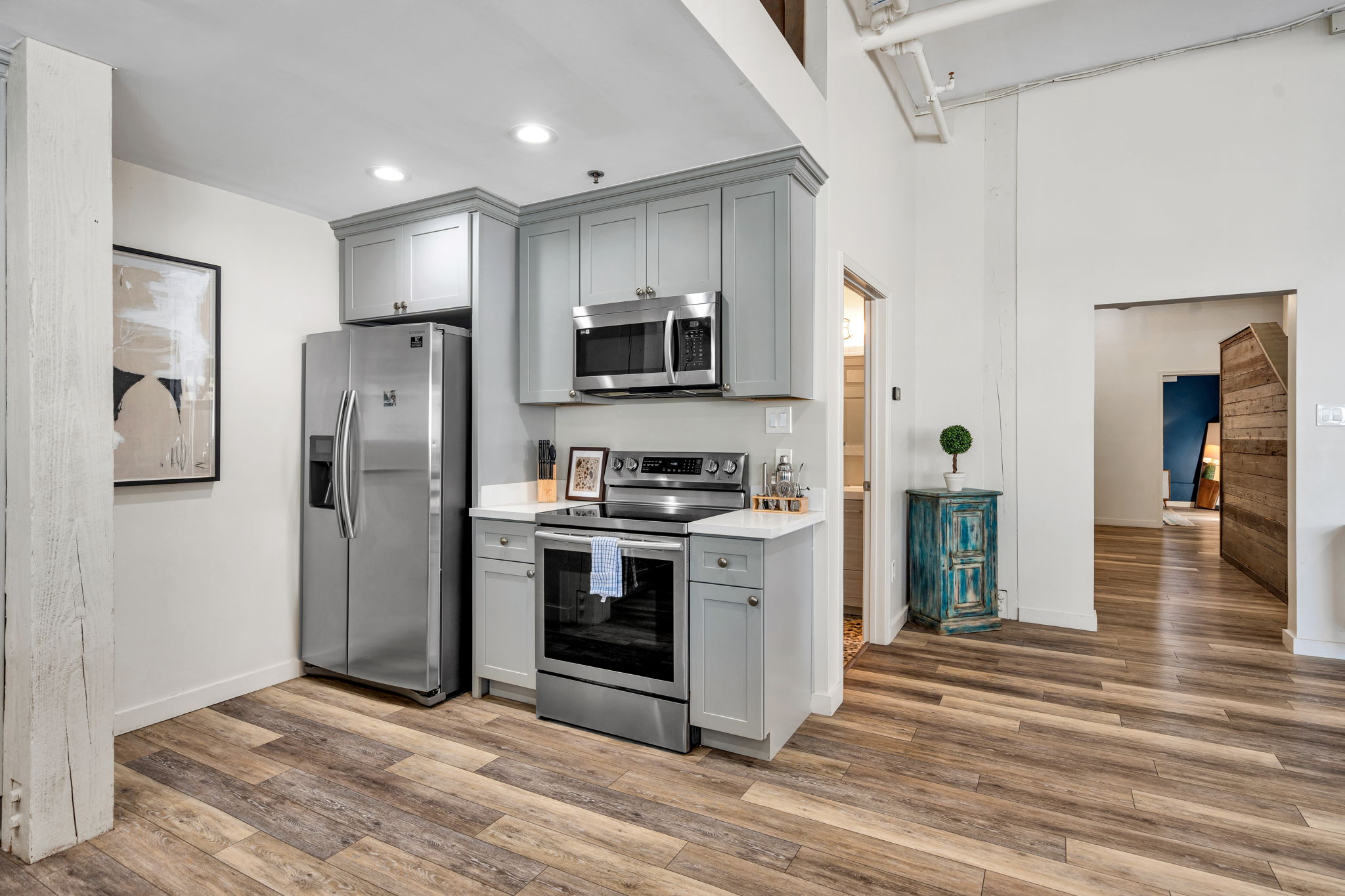 The kitchen in The Ivories suite, with gray cabinets and stainless appliances