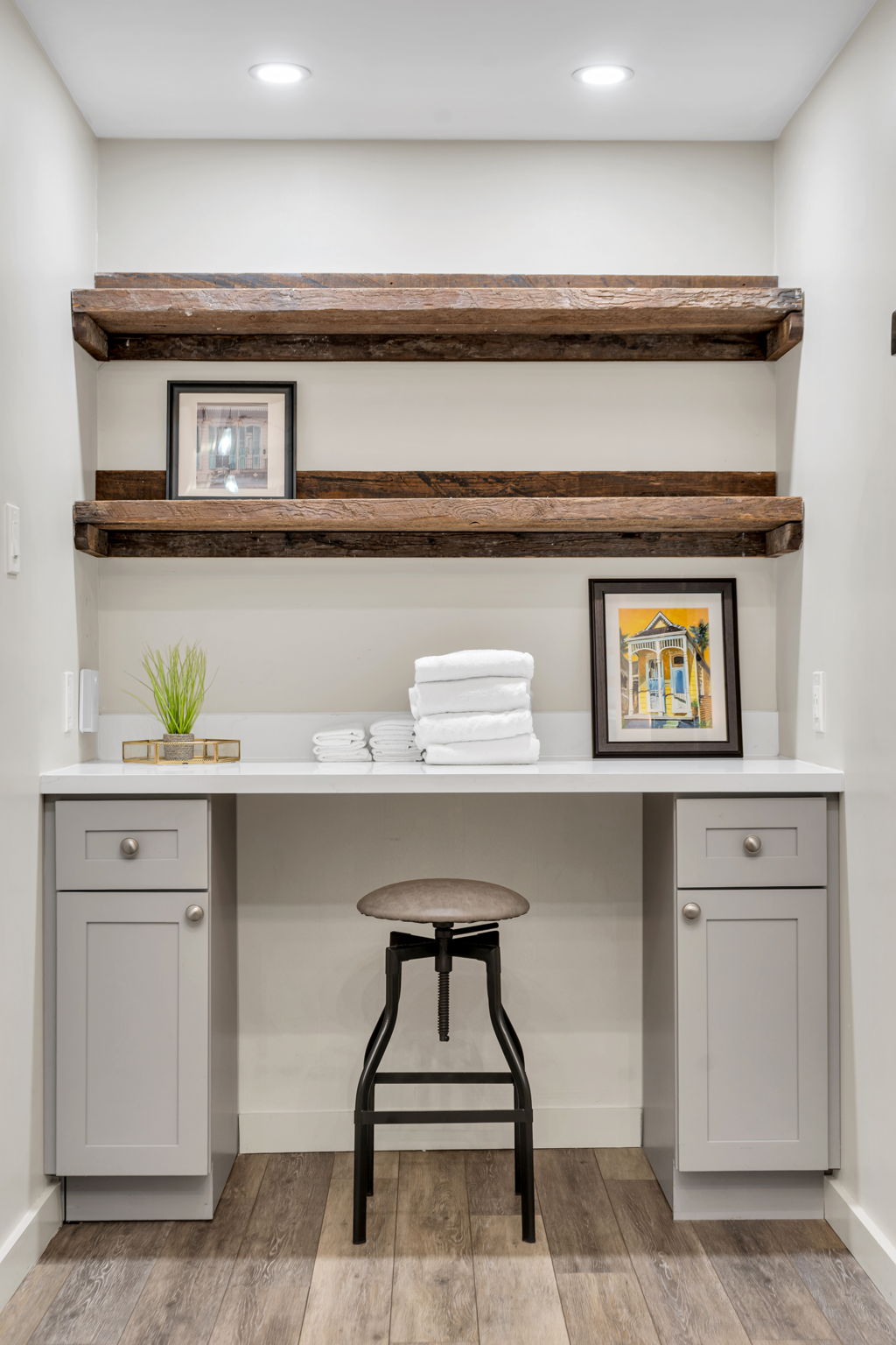 A built-in desk nook in The Ivories suite, with reclaimed-wood shelves and folded towels