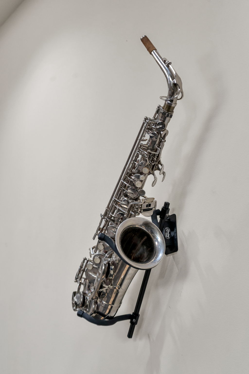 A silver saxophone mounted on the wall in The Reed suite