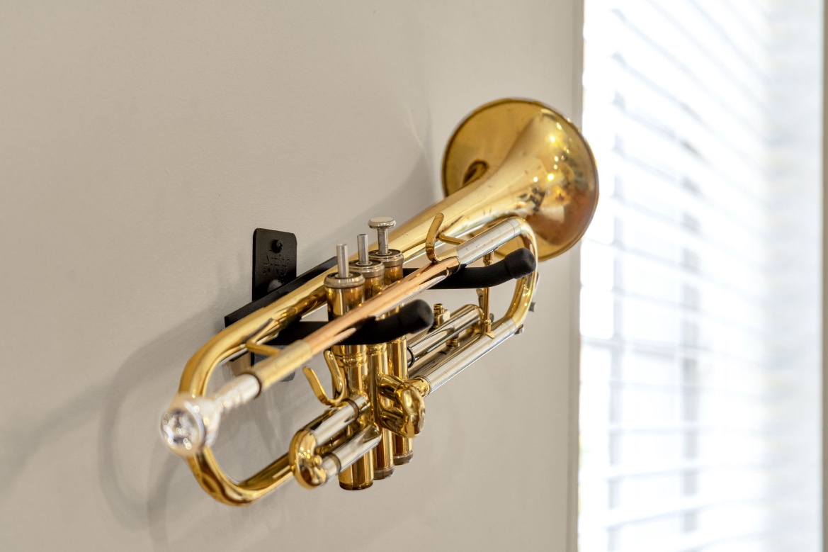 A brass trumpet mounted on the wall in The Bell suite