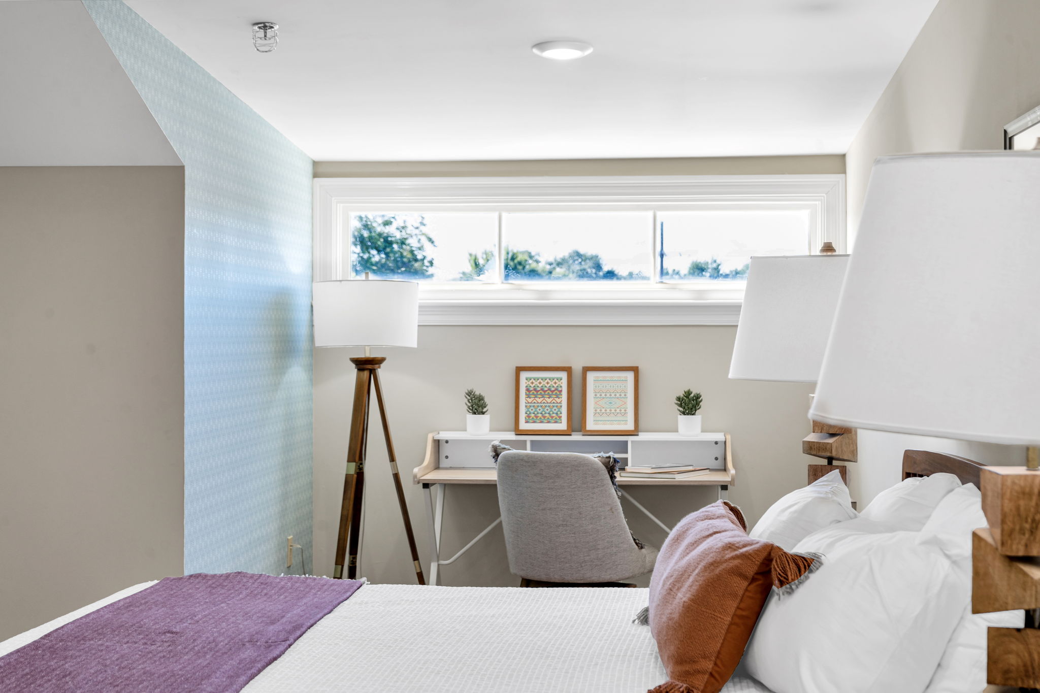 The same bedroom from the other side, looking toward the desk under the wide window in The Bell suite