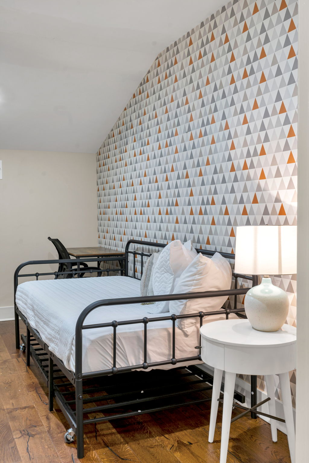 The daybed in The Licorice suite, seen from a second angle against the triangle-patterned wallpaper