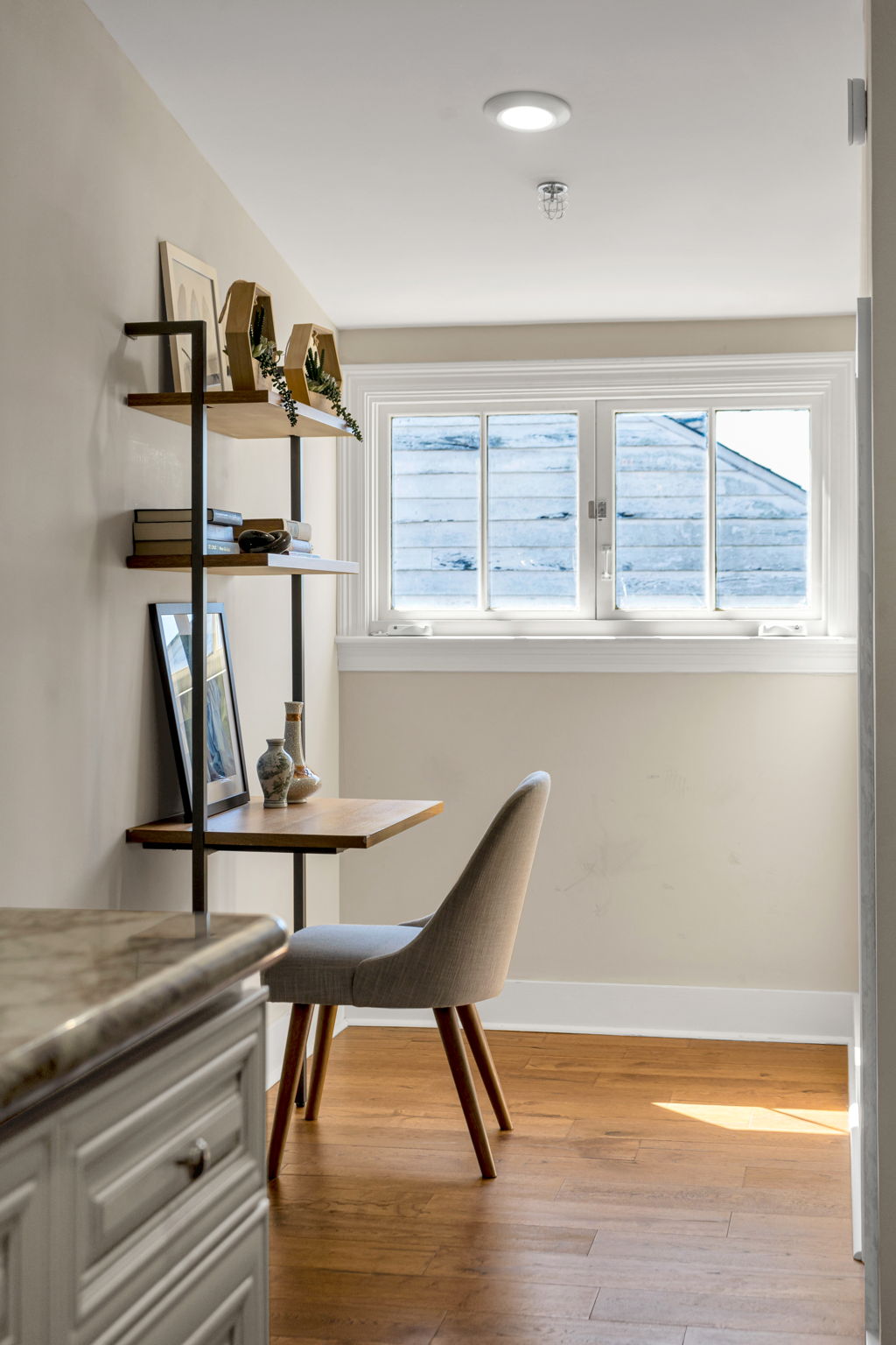 The ladder-shelf desk nook under the window in The Delta suite